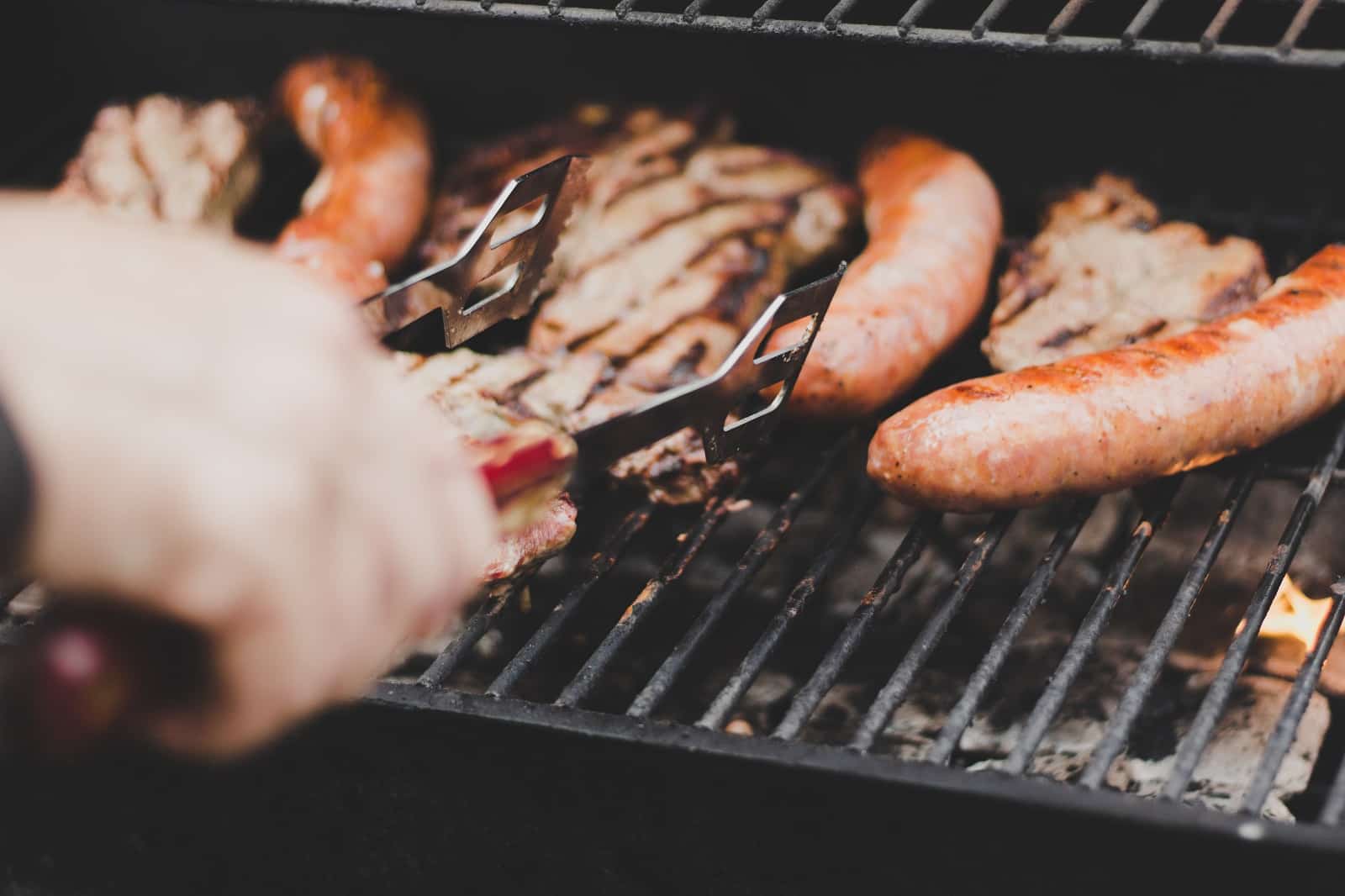 hot dogs and chicken on a grill