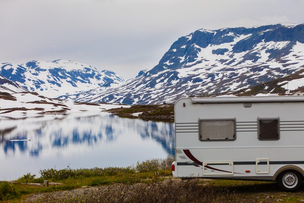 A camper parked in a snowy landscape that needs a space heater inside