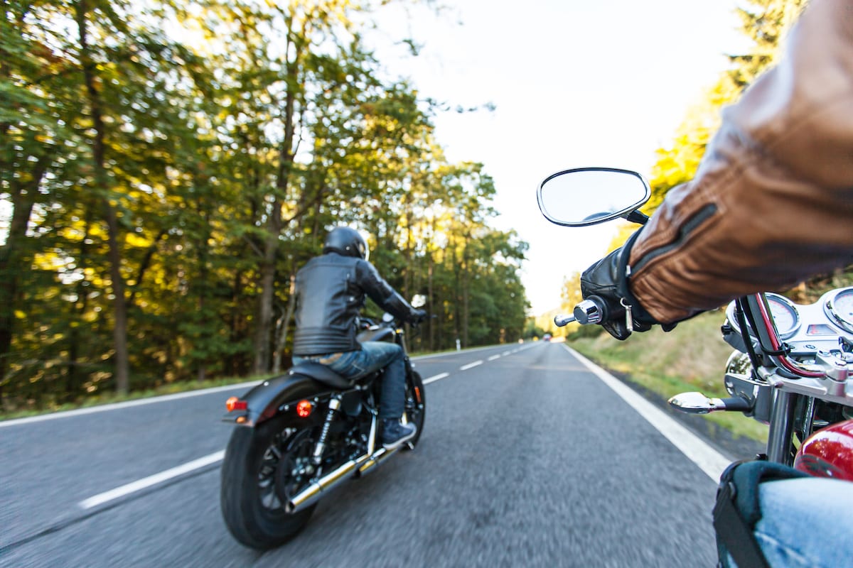 Man seat on the motorcycle on the forest road